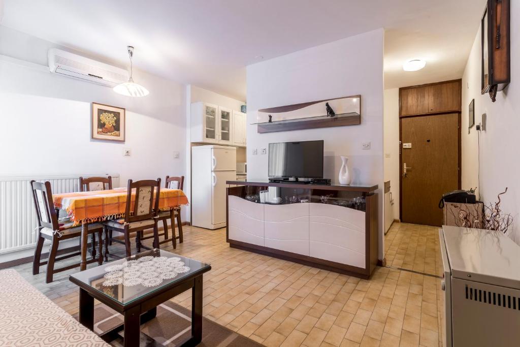 a living room with a kitchen and a dining room at Apartment Kossi in Split