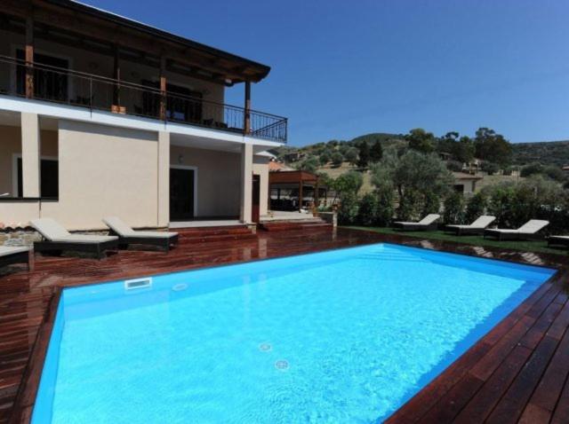 a large blue swimming pool in front of a house at I Colori Del Cilento in Montecorice