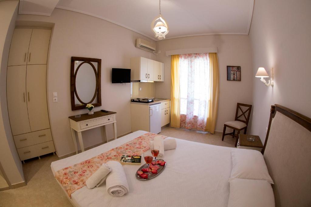 a bedroom with a bed with a plate of fruit on it at Bellarias House in Nydri