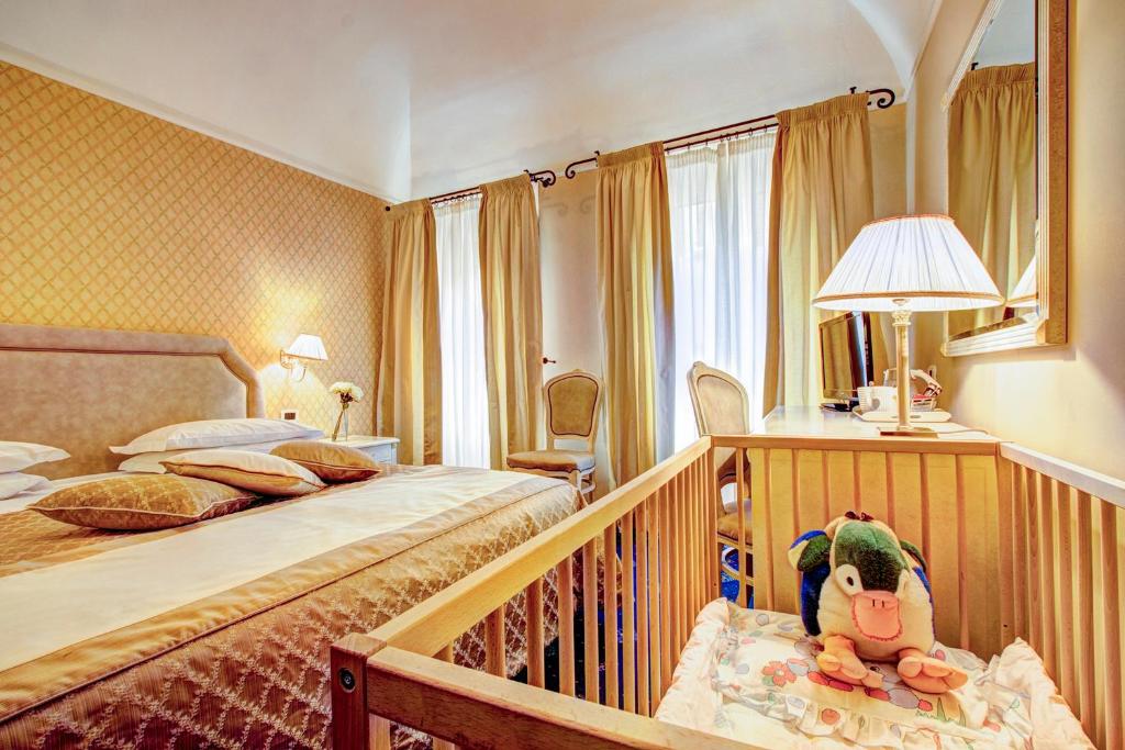 Postel nebo postele na pokoji v ubytování Hotel La Locanda
