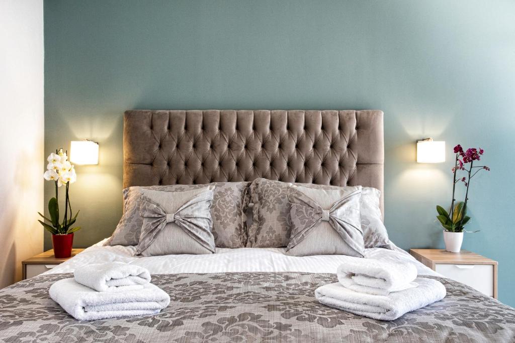 een slaapkamer met een groot bed en handdoeken bij Volos View in Volos