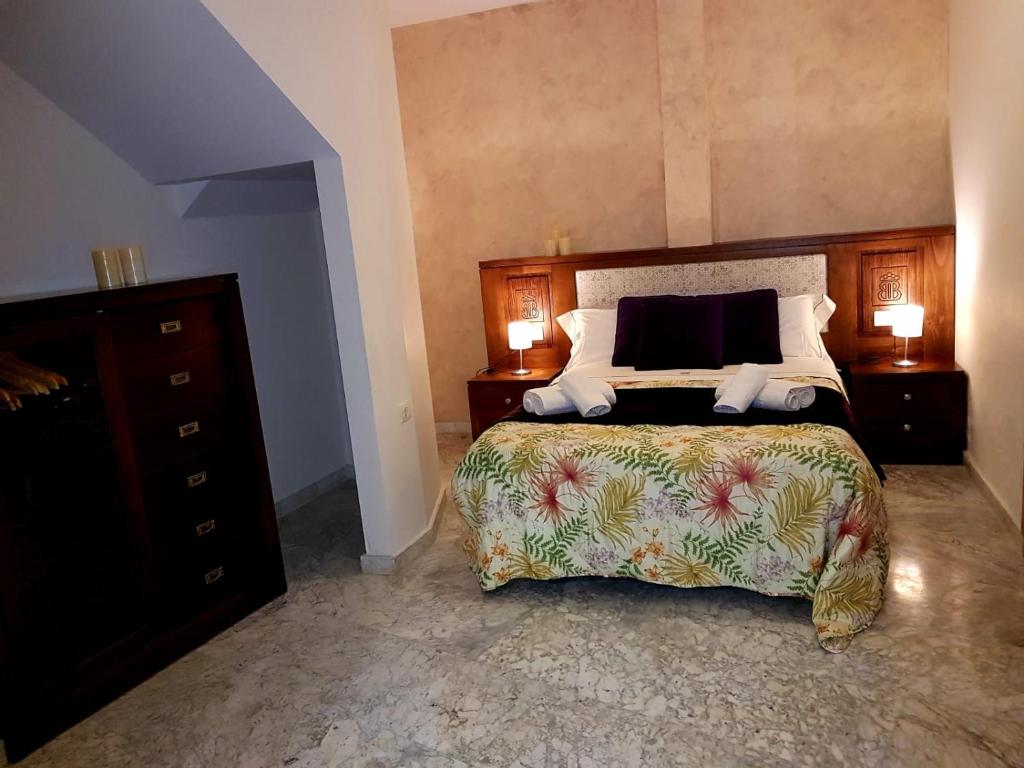 a bedroom with a large bed and two night stands at Apartamento Realejo centro ciudad in Granada