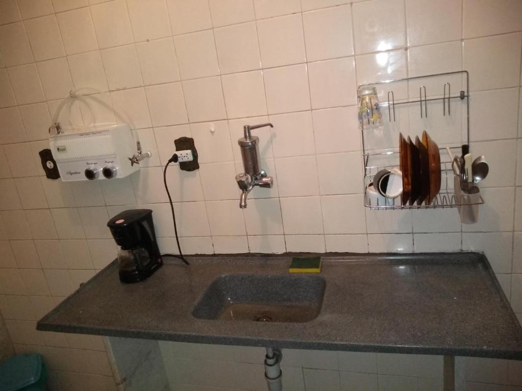 a kitchen counter with a sink in a room at Campo Grande Pousar ou morar in Rio de Janeiro