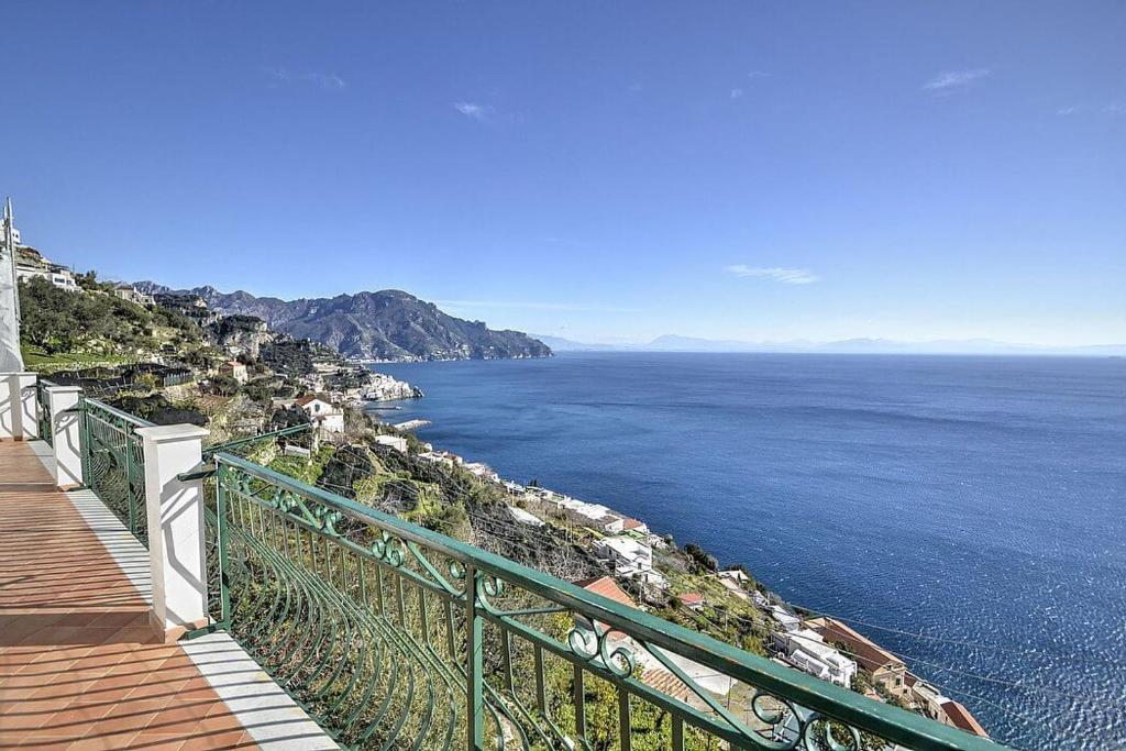 - une vue sur l'océan depuis une bluff avec une balustrade verte dans l'établissement CASA LONE, à Amalfi