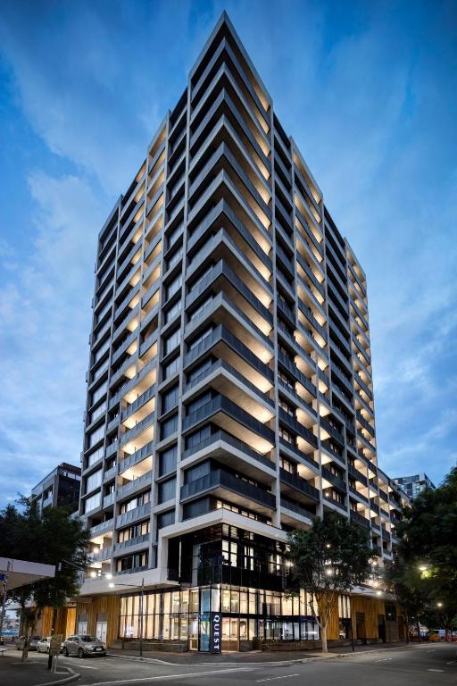 a tall building with many windows on a street at Quest NewQuay in Melbourne