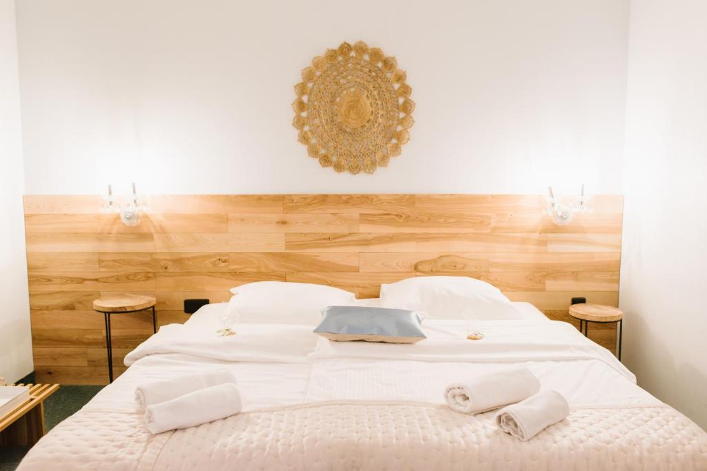 a bedroom with a white bed with two towels on it at Hotel Rezydencja Solei in Poznań