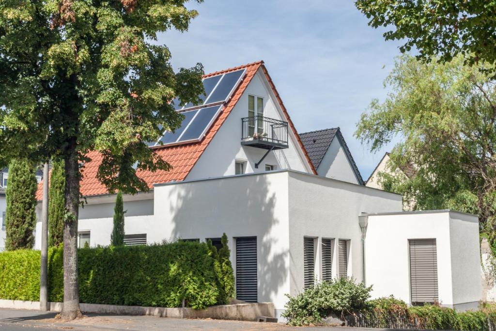 a white house with a red roof at Ferien.Wohnung.Sartoris in Bad Neuenahr-Ahrweiler