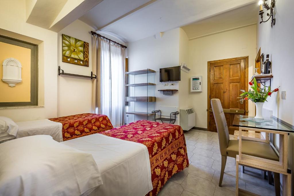 Postel nebo postele na pokoji v ubytování Hotel Collodi Firenze