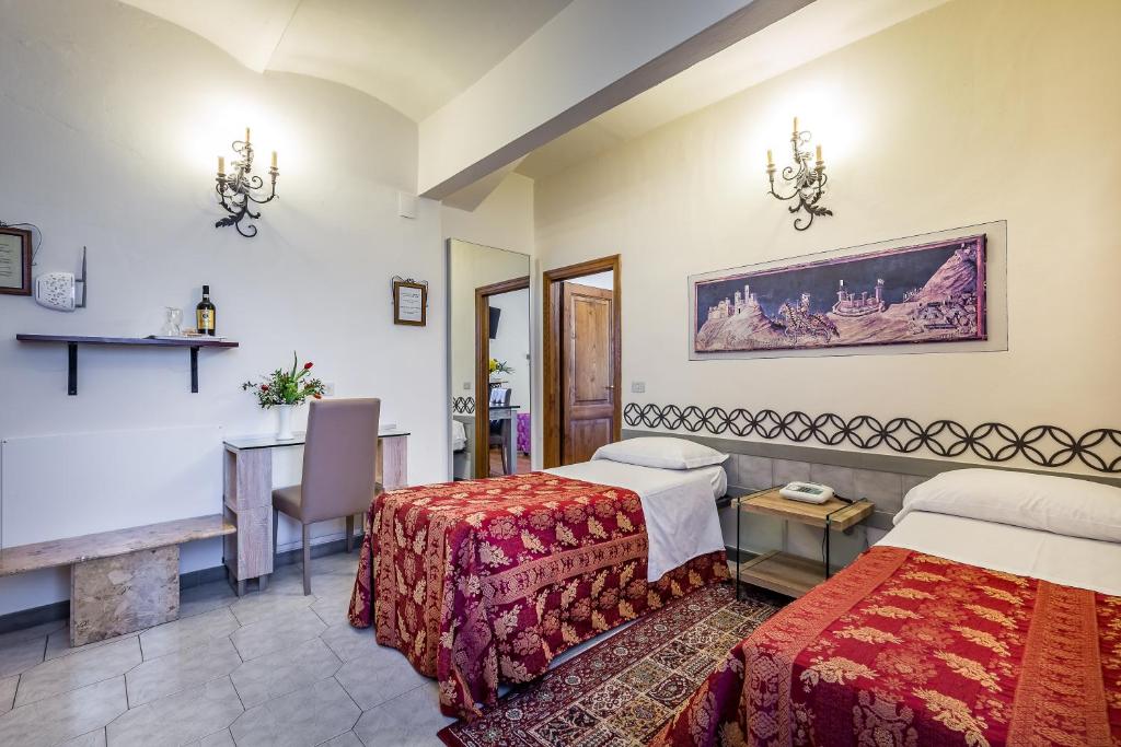 Postel nebo postele na pokoji v ubytování Hotel Collodi Firenze