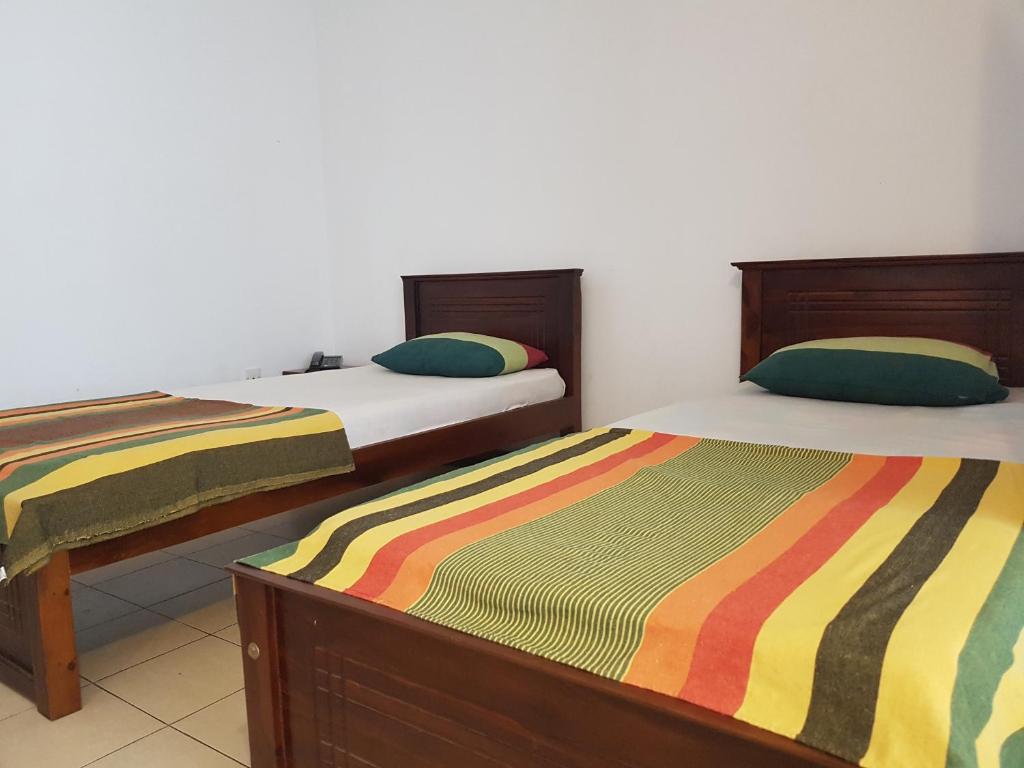 Postel nebo postele na pokoji v ubytování Chamaya Holiday Inn