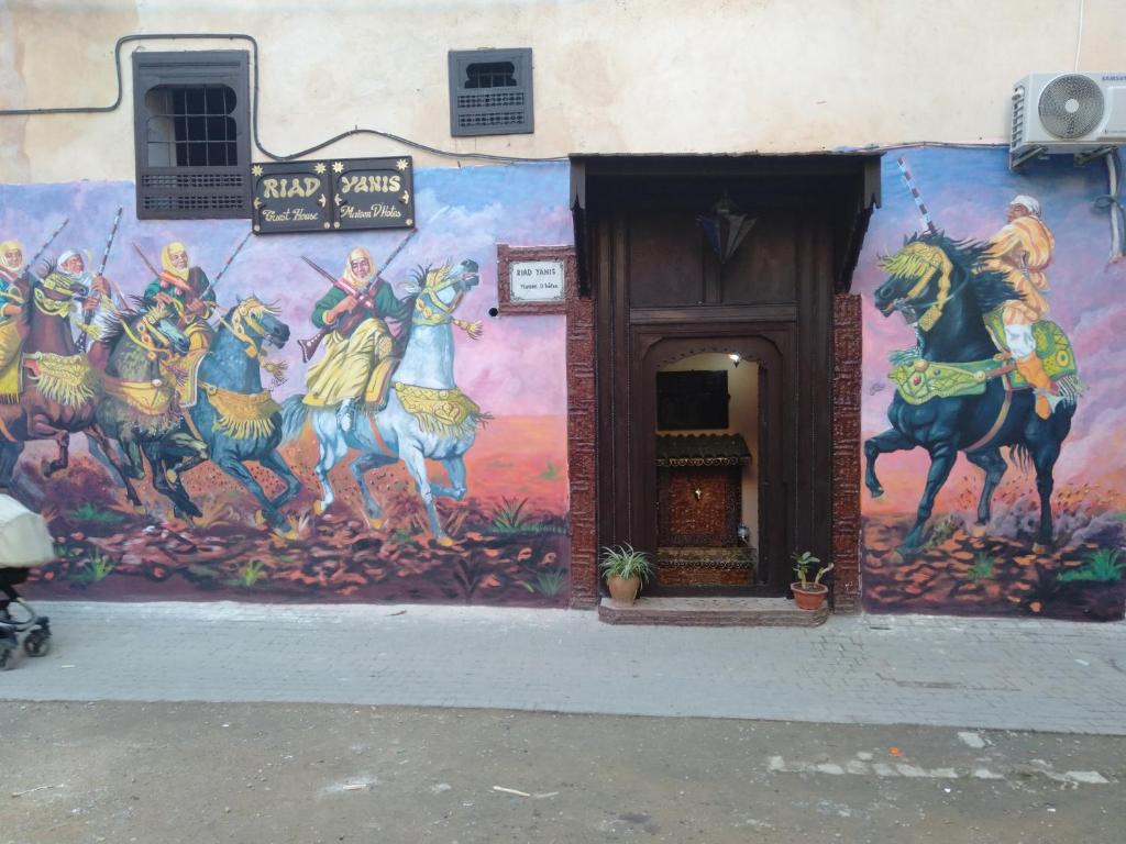 a mural on the side of a building at Riad Yanis in Meknès