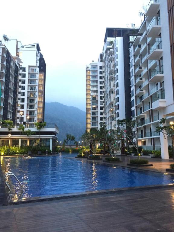 a swimming pool in a city with tall buildings at 12pax Golden Shine Homestay @Midhills Genting in Genting Highlands