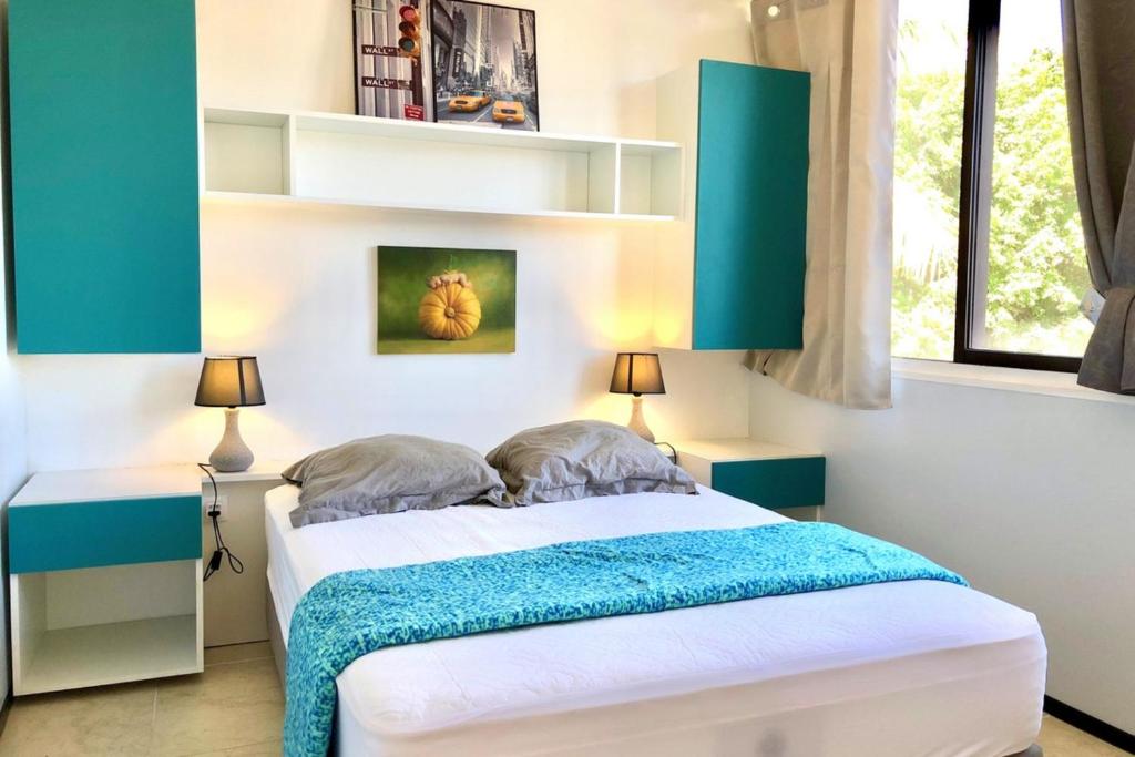 um quarto com uma cama azul e branca em Ery apartment - Papeete downtown - 2 bedrooms - AC - WiFi - 6 pers em Papeete