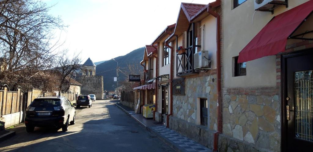 a car parked on the side of a street at Hotel Bagineti in Mtskheta