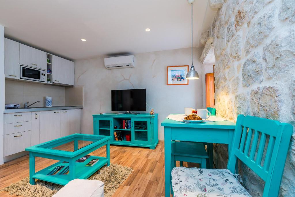 a kitchen with a blue table and two chairs at Historical Old town apartments in Dubrovnik