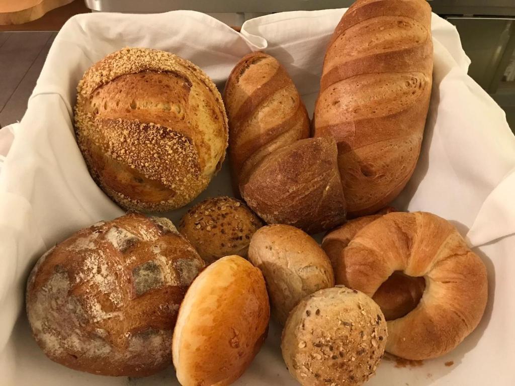 a bunch of different types of bread in a basket at Palazzo Mysanus Samedan in Samedan