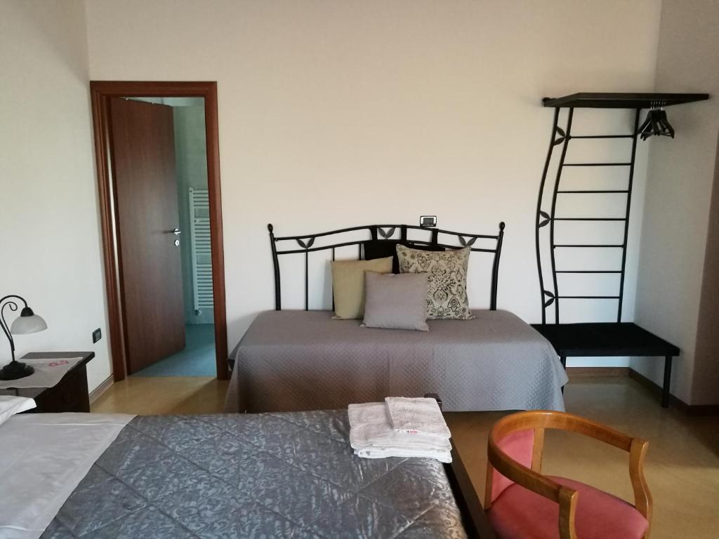 Postel nebo postele na pokoji v ubytování B&B L'Upupa