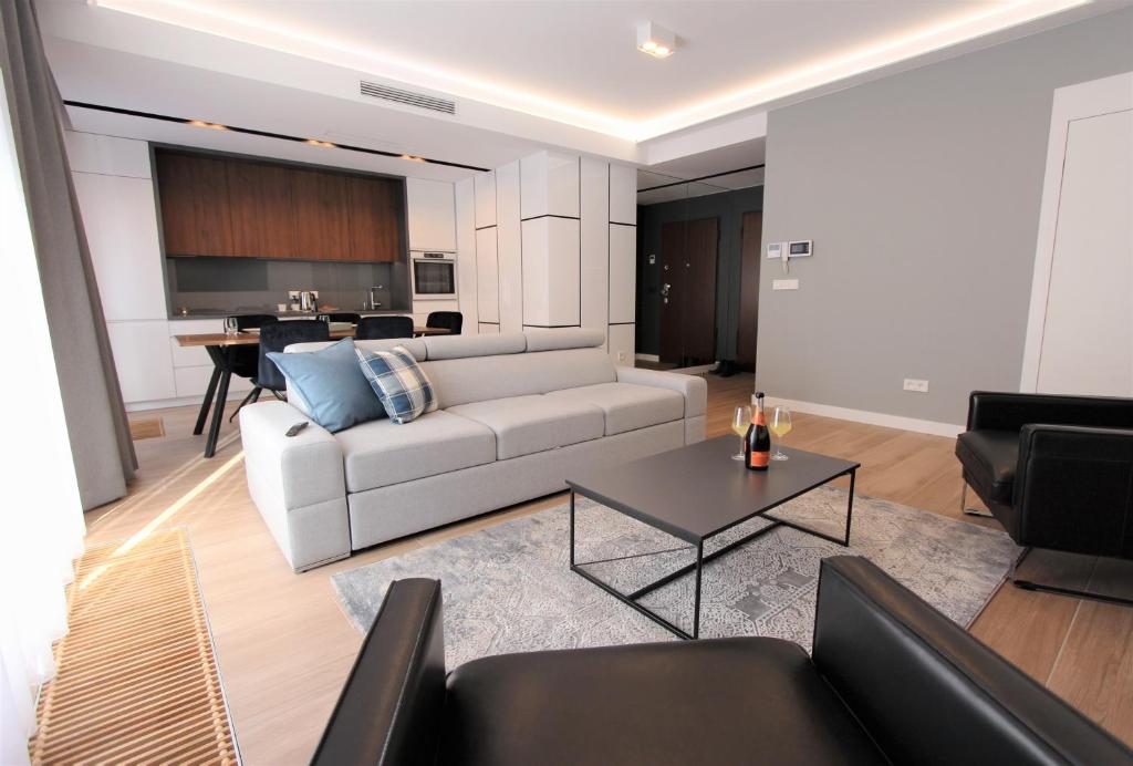 a living room with a couch and a table at Lubicz Luxury Apartment in Kraków