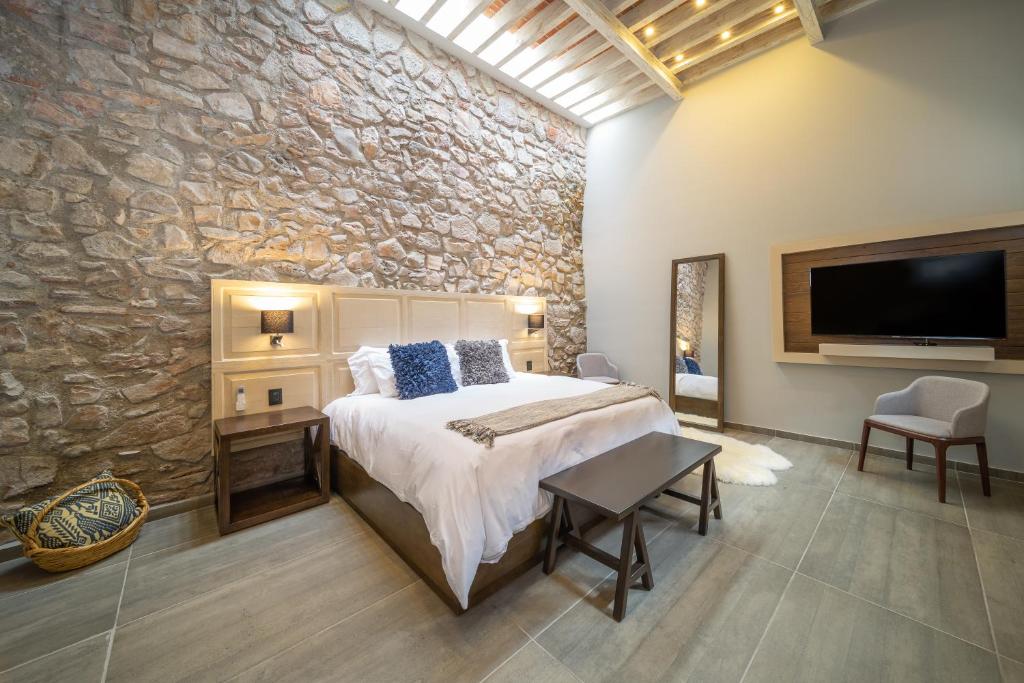 Postel nebo postele na pokoji v ubytování Hotel Casa Once
