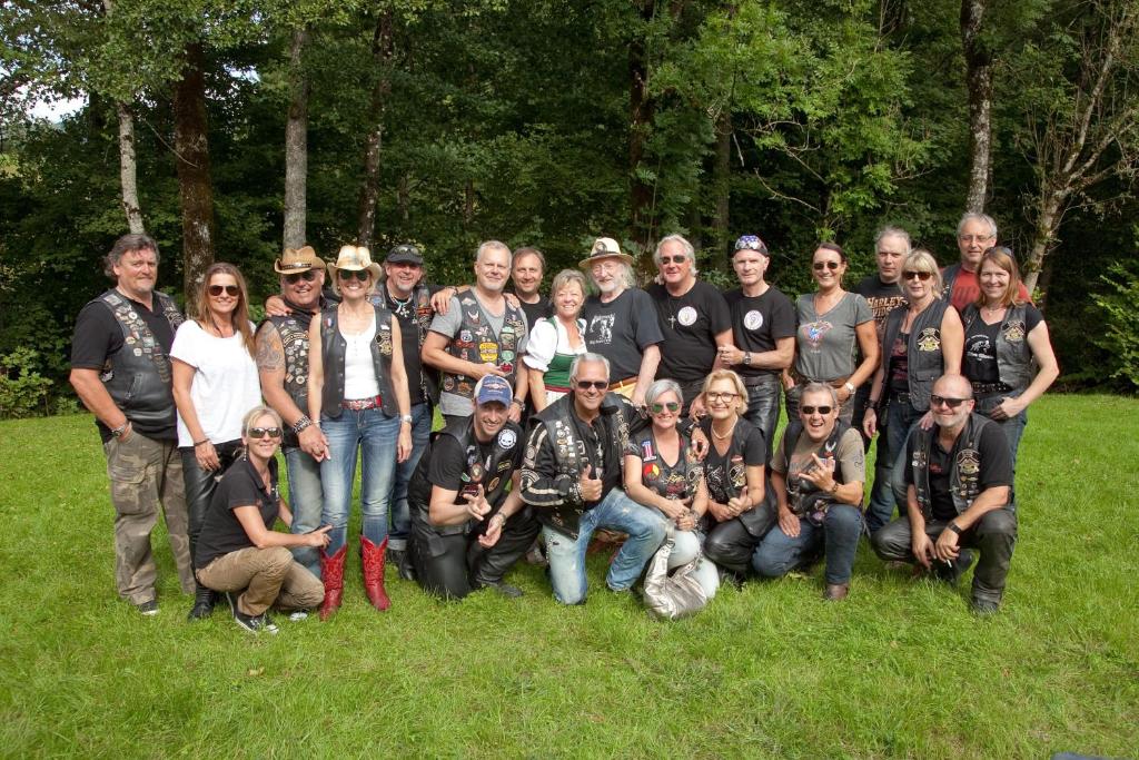 a group of people posing for a picture in a field at Erlachmühle in Mondsee