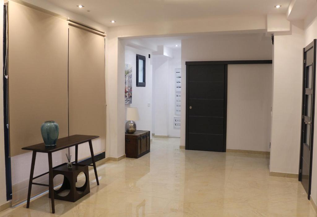 a hallway with a table and a black door at Valencia Town Center New Apartments in Valencia