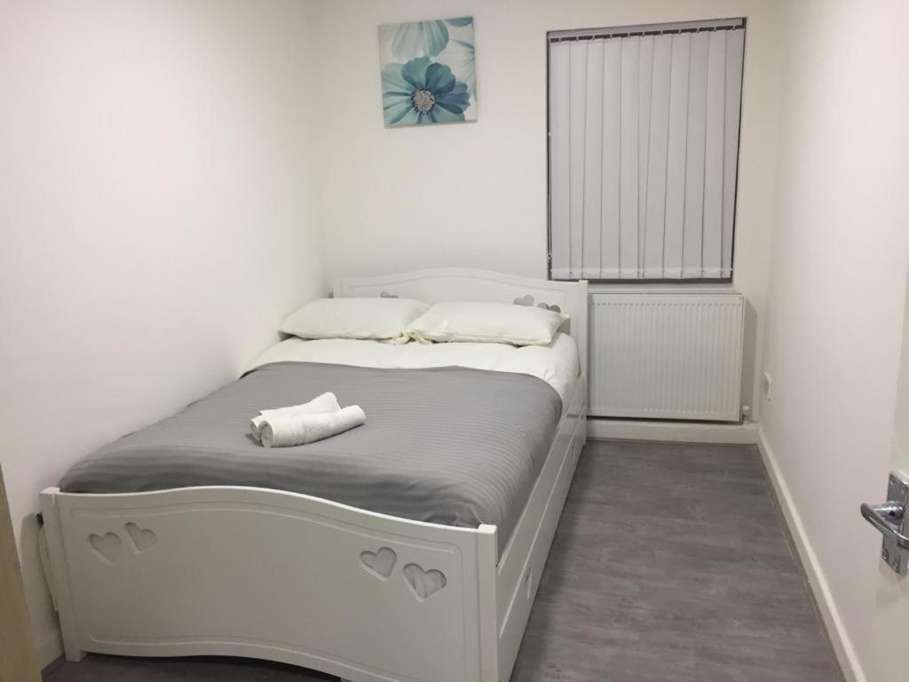 a small bedroom with a white bed in a room at Sama's Stylish Room 3 in Manchester