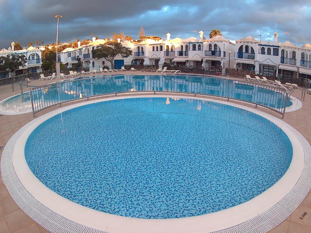 a large swimming pool in front of some buildings at Playmar Sun Maspalomas in Playa del Ingles