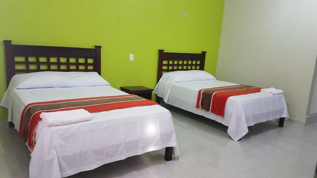 Postel nebo postele na pokoji v ubytování HOTEL VILLA CALAKMUL