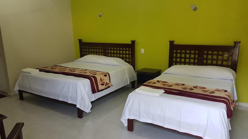 Postel nebo postele na pokoji v ubytování HOTEL VILLA CALAKMUL