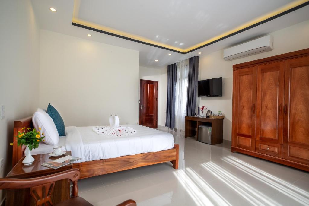 Postel nebo postele na pokoji v ubytování Sum villa Hoi An