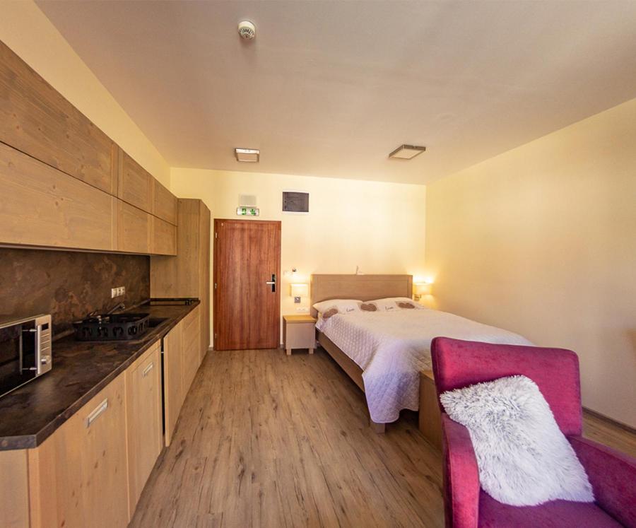 A bed or beds in a room at Apartmány Tatry