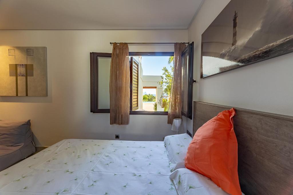 a bedroom with a bed and a window at Can Bernadet in San Jose