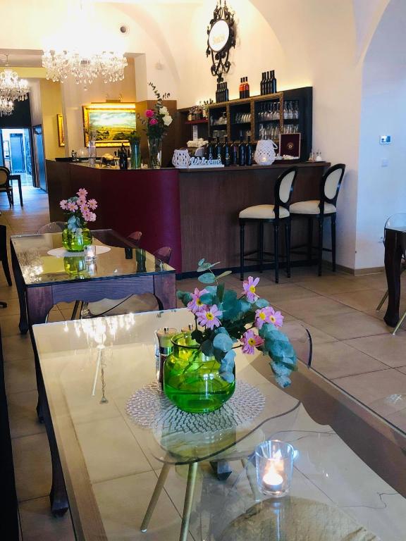 a lobby with a table with flowers on it at Hotel Bouček in Kroměříž