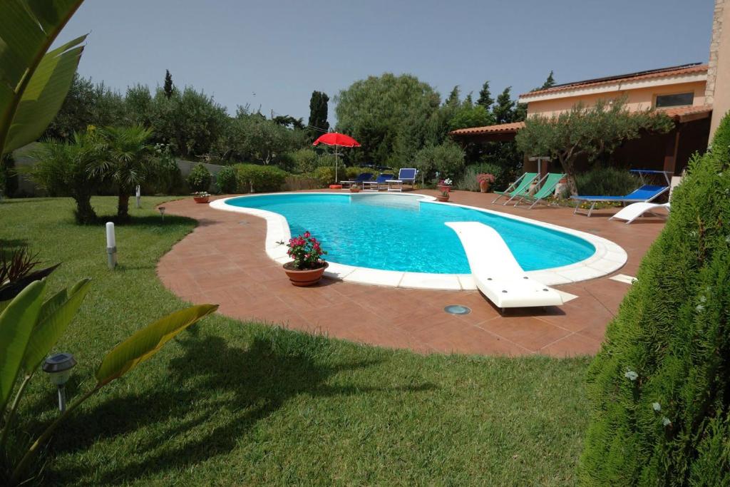 a swimming pool with a slide in a yard at Villa Paladino in Castellammare del Golfo