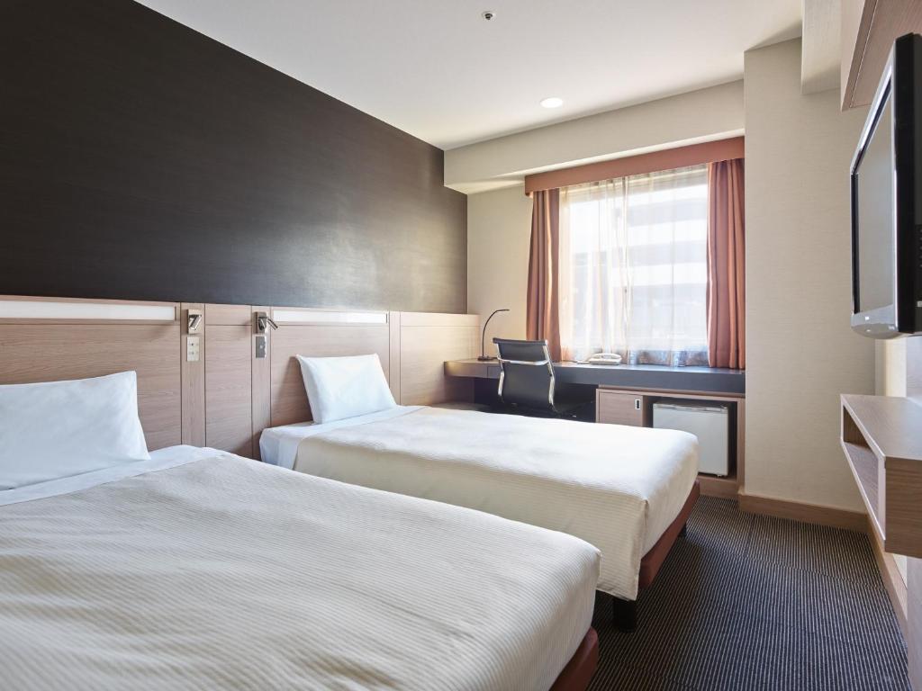 Postel nebo postele na pokoji v ubytování Mitsui Garden Hotel Okayama