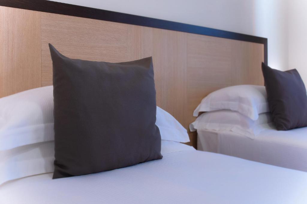 Łóżko lub łóżka w pokoju w obiekcie CDH Hotel Modena