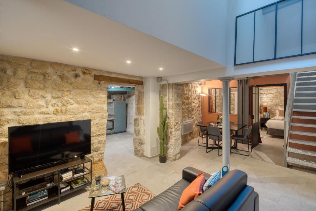 un salon avec un canapé et une télévision dans l'établissement Gravilliers, à Paris