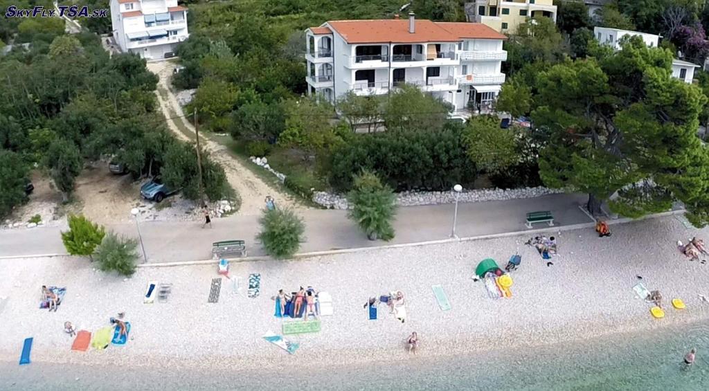 a group of people on a beach near the water at LEGIN in Živogošće