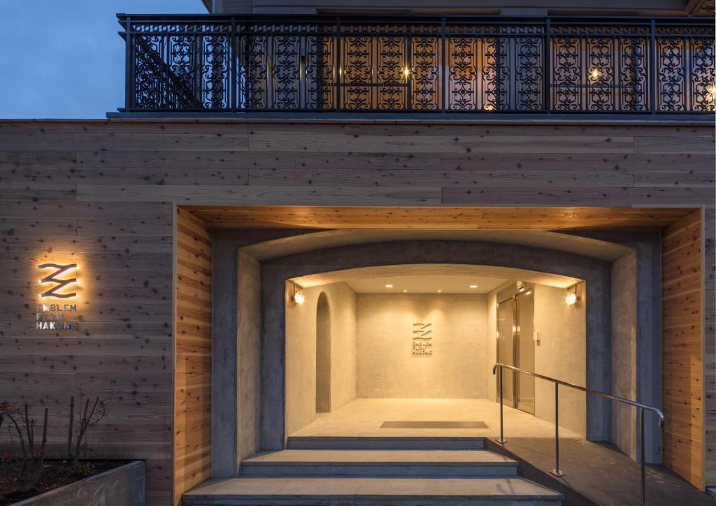 a staircase leading up to a building with a balcony at Emblem Flow Hakone in Hakone