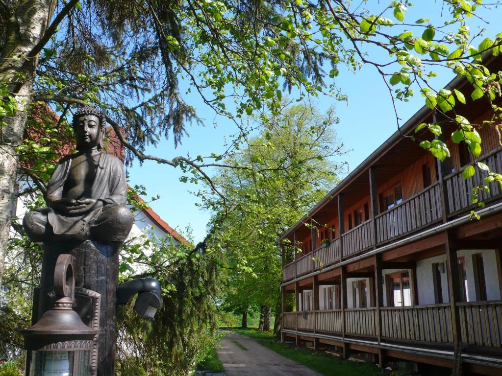 a statue of a man in front of a building at Iseler Mühle in Bremervörde