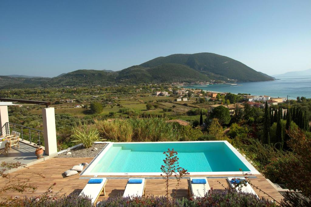 a swimming pool with a view of the ocean at Anemos Luxury Villas in Vasiliki