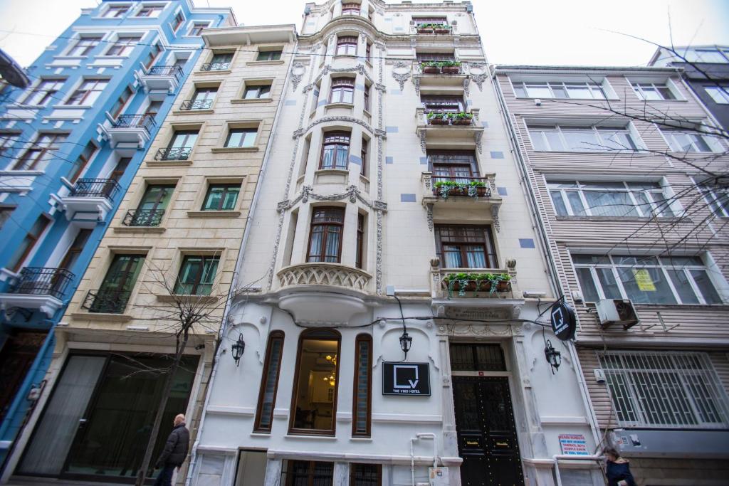 a tall white building with windows and plants on it at The Void Hotel - Sisli Istanbul in Istanbul