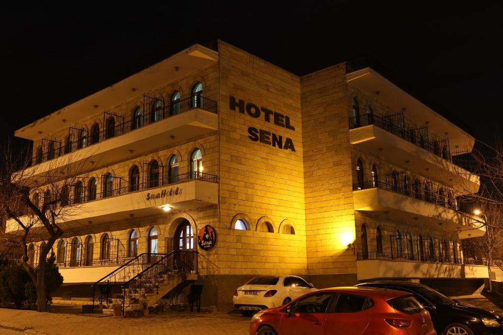 ein Hotel mit Autos, die nachts draußen geparkt sind in der Unterkunft Sena Hotels in Ürgüp