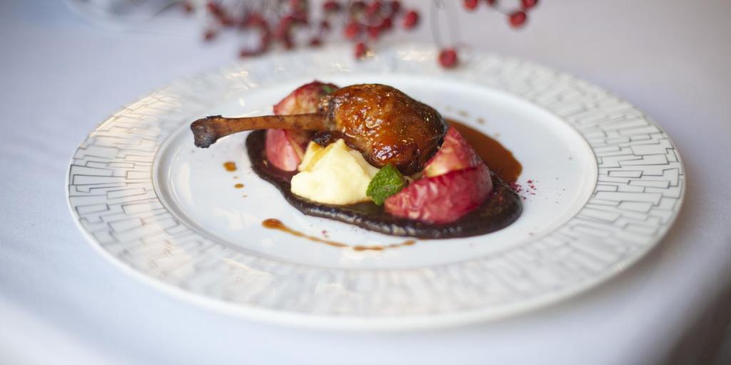 a white plate with a piece of food on it at Pushka INN hotel in Saint Petersburg
