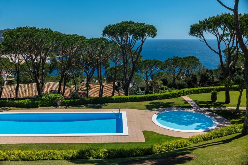 a swimming pool with a view of the ocean at E-2 CALELLA DE PALAFRUGELL 8 PAX in Calella de Palafrugell