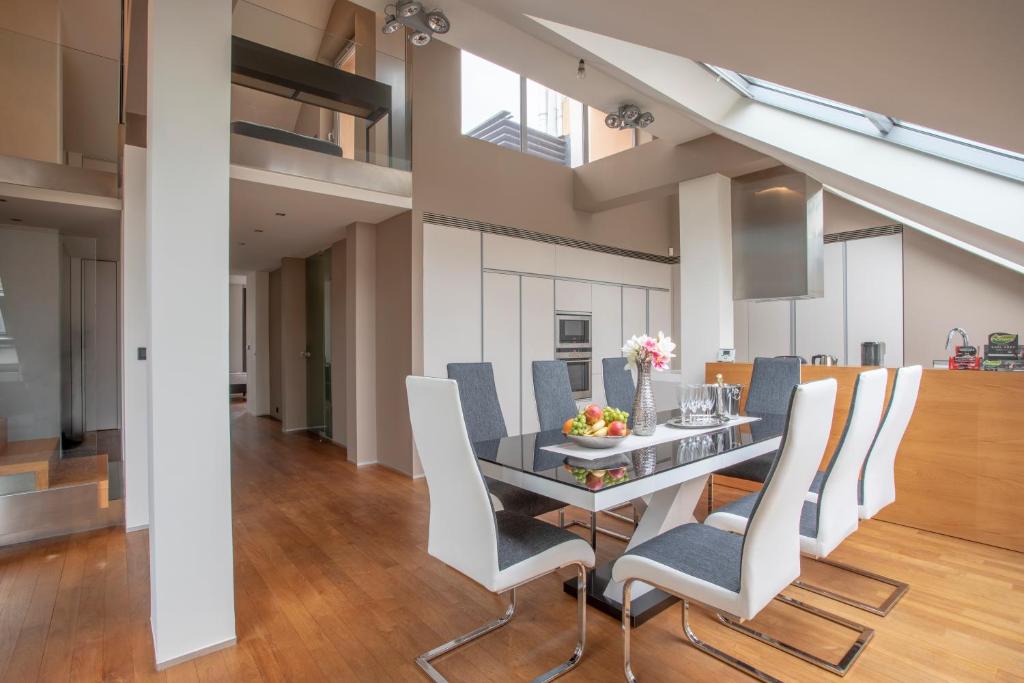 a dining room with a table and chairs at LUXURY CENTRAL DUPLEX WITH TERRACE in Prague