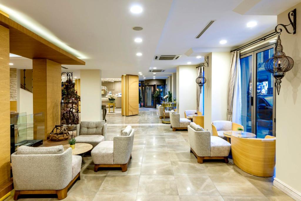 a lobby of a hospital with chairs and tables at Hotel Yasmak Sultan in Istanbul