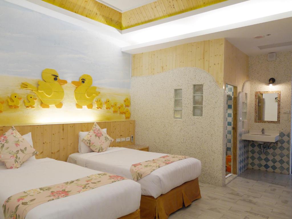 Postel nebo postele na pokoji v ubytování Kenting Sin Sin Hotel IIl