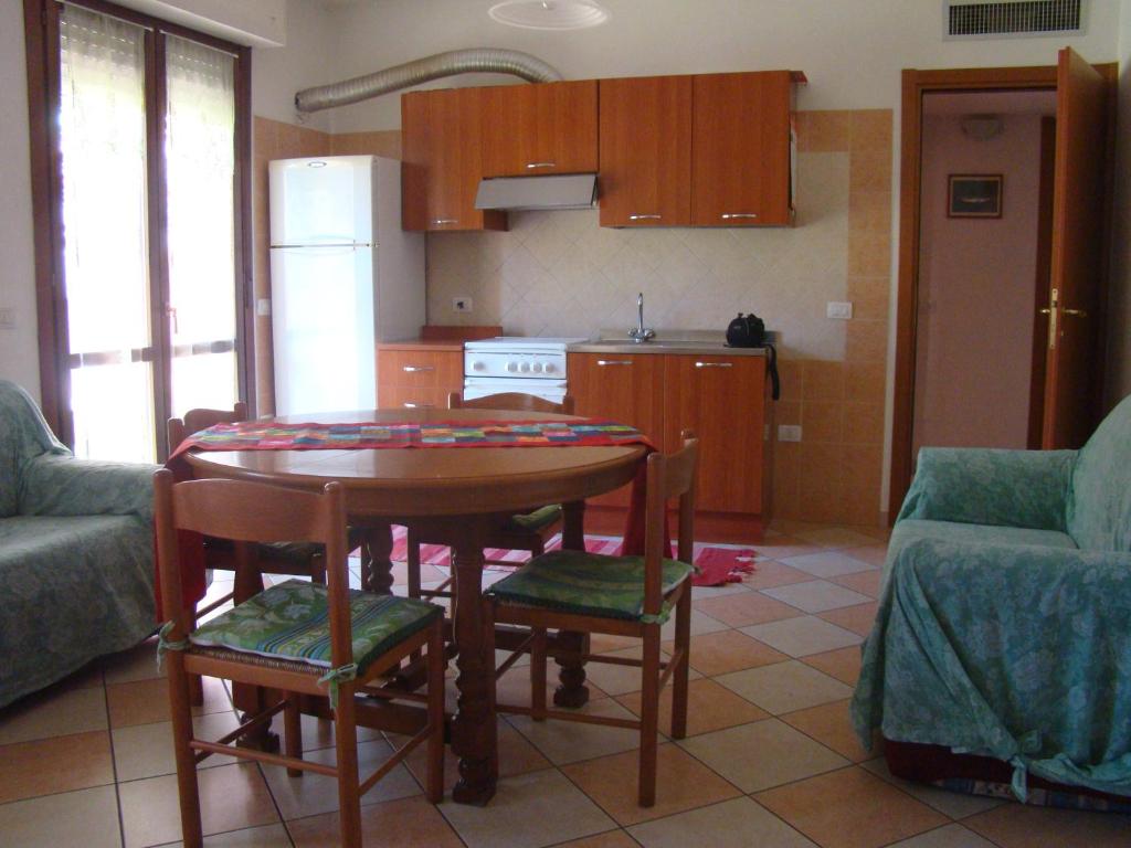 a kitchen with a table and chairs in a room at Appartamento Deledda in Muravera