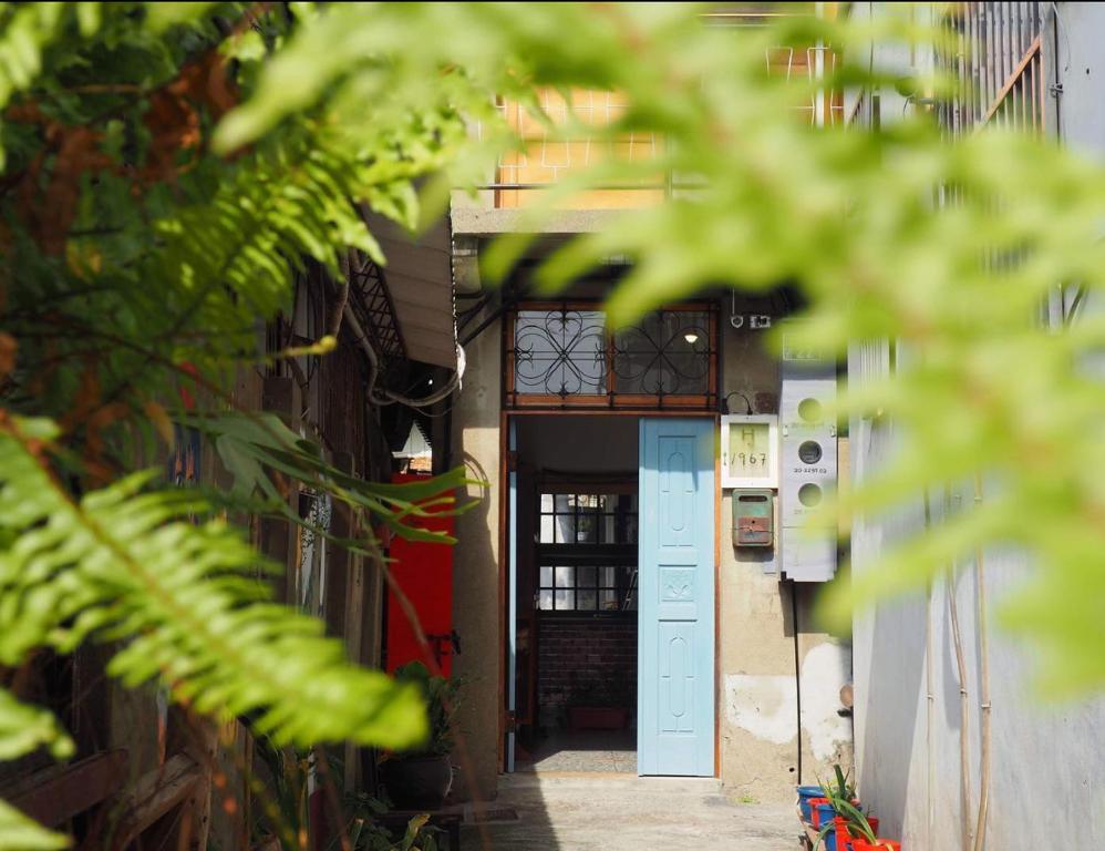 a hallway with a blue door in a building at H. 1967 in Changhua City